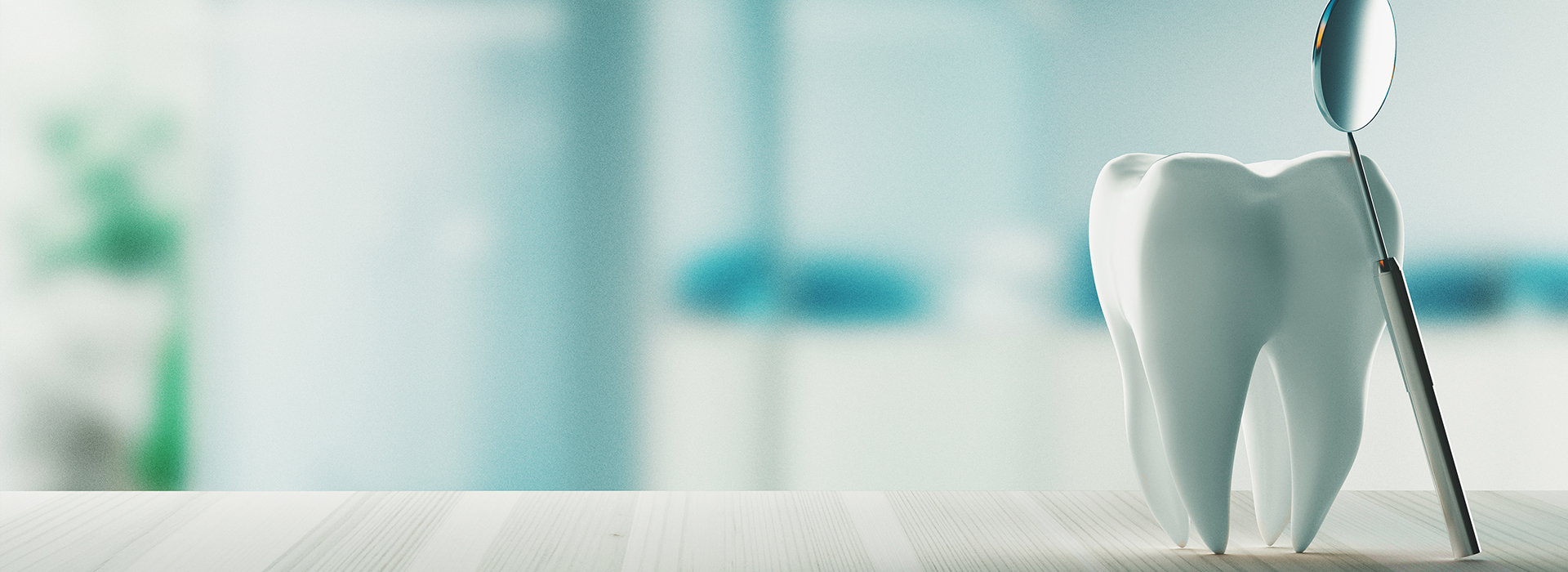 An image of a dental office with a toothbrush and a model of a human head, set against a blurred background.